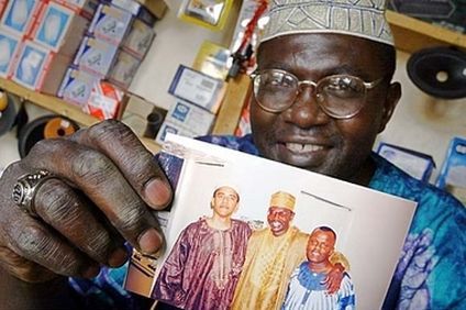 Where there's smoke there's fire! - Malik Obama Holds The Photo Of Barack Hussein Obama His Brother.