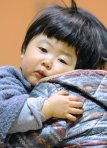 A young evacuee from vincity of Tokyo Electric Power Co.'s Fukushima Nuclear Plant shows fatigue at a evacuation shelter in Kawamata, Fukushima Prefecture Sunday March 13, 2011. (AP Photo/Kyodo News) JAPAN OUT, MANDATORY CREDIT, NO SALES IN CHINA, HONG KONG, JAPAN, SOUTH KOREA AND FRANCE