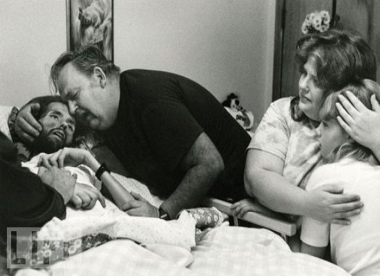 AIDS sufferer David Kirby is embraced by his father