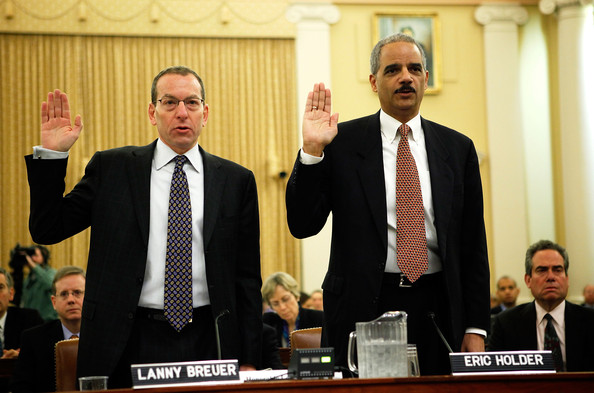 U.S. Attorney General Eric Holder (R) and Assistant Attorney General Lanny Breuer of the Criminal Division (L) are sworn in during a hearing before the Financial Crisis Inquiry Commission January 14, 2010 on Capitol Hill in Washington, DC. The commission continued its hearing to examine the root causes of the recent financial crisis and how now to prevent it in the future.