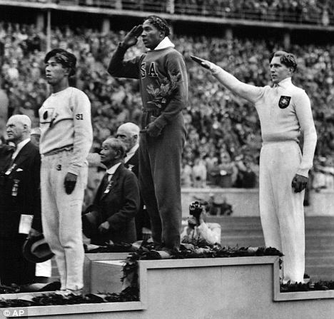Snubbed: American sporting hero Jesse Owens taking gold at the Berlin Olympics in 1936 after Hitler claimed he had been humiliated by a 'sub-human'.