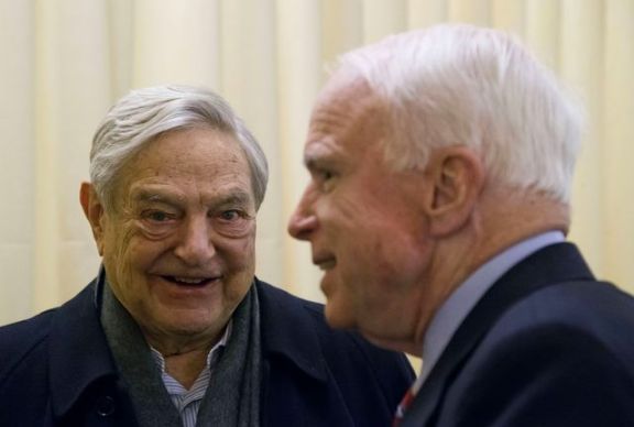 Chairman of Soros Fund Management George Soros, left, talks with U.S. Senator John McCain, right, during the World Economic Forum in Davos, Switzerland, Thursday, Jan. 23, 2014.. (AP Photo/Michel Euler)