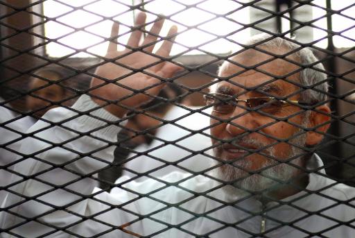 Ahmed Gamil/AFP/File Egyptian Muslim Brotherhood leader Mohamed Badie waves from inside the defendants cage during the trial of Brotherhood members on February 3, 2014 near Cairo's Turah prison