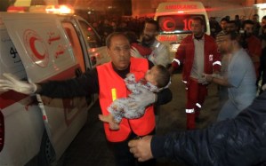 Palestinian medics carry a wounded baby into the Al-Shifa hospital in Gaza City following an Israeli air strike.