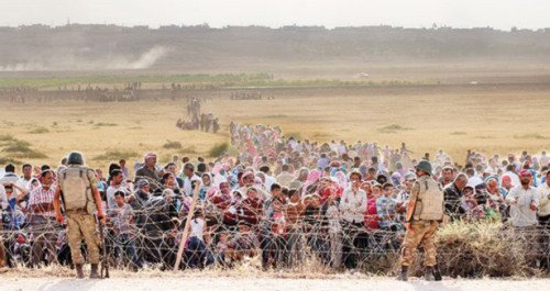 Turkish Brotherhood soldiers block Syrian refugees at border near Kobani.  Turkey and the U.S. are cynically using the Kurdish people as a bargaining chip in a strategy of conquest against Syria's Sovereignty.