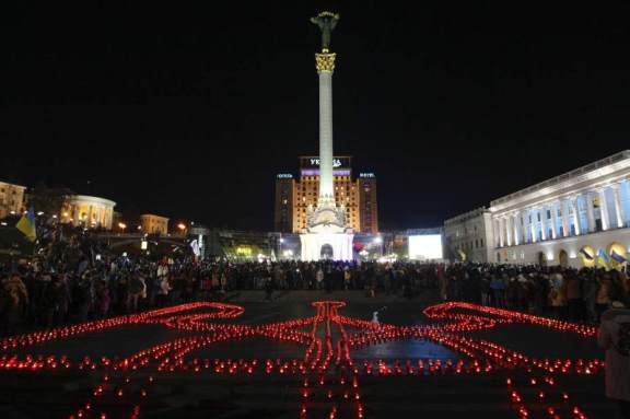 People take part in a rally at the Independence Square in Kiev November 21, 2014. Ukrainians marked the first anniversary of Those Who Were Murdered In The European Union Coup. U.S. Financed Change In The Country's Constitutional Leadership And Seated A Pro NWO Puppet Named Poroshenko Who IS Trying To Bring Ukraine Closer To The Banker's EU.