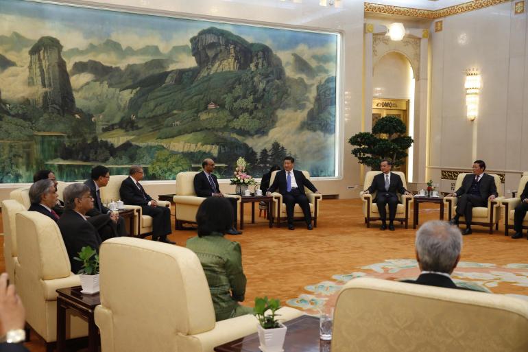 China's President Xi Jinping (3rd R) meets with the guests at the Asian Infrastructure Investment Bank launch ceremony at the Great Hall of the People in Beijing
