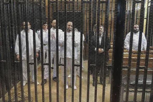 Ex Puppet President Of Egypt Mohamed Morsi and several other NWO Mercenary Muslim Brotherhood members in the defendants cage.
