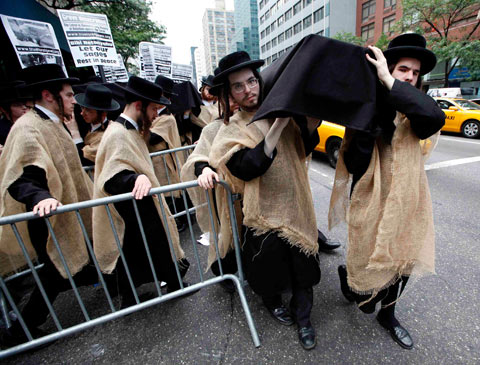 Orthodox Jewish demonstrators carry a mock coffin in protest against the government of Israeloutside the Israeli mission to the United Nations, in New York