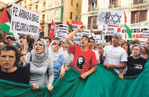 Demonstrators shout slogans during an anti-Israel protest in front of the foreign ministry in Madrid. Israeli marines stormed a Turkish aid ship bound for Gaza on Monday and 10 pro-Palestinian activists were killed, triggering a diplomatic crisis and plans for an emergency session of the U.N. Security Council. 