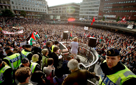 Demonstrators listen to speeches during an anti-Israel protest in downtown Stockholm, Sweden.